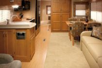 The living/dining areas in the Newmar Canyon Star 3920 motorhome include raised-panel cabinet doors and Flexsteel furniture.