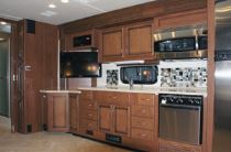 The galley in the 2011 Fleetwood Expedition provides coach cooks with many residential amenities, including a three-burner stove, a convection-microwave oven, and a conventional oven.