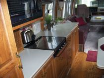 The galley features the original Corian countertops and oak cabinetry.