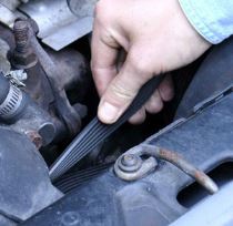 Inspect the underside of serpentine drive belts for signs of wear -- cracking, chinking, or missing chunks.