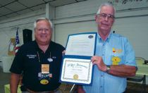 California Heartland president Ron Neve (far right) dislpays the 20th anniversary certificate presented to the chapter by Dick Gibbs, Western Motor Home Association Central Area vice president.