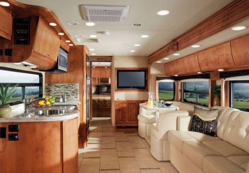 Monaco Vesta interior features - curved hardwood cabinet doors, tile flooring, Ultraleather upholstery, and soffit lighting