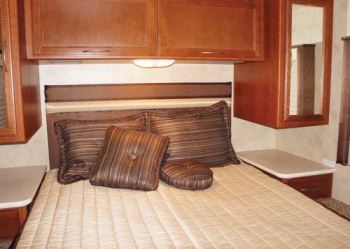 In the rear bedroom of the 29-foot A.C.E. motorhome, storage is available under the bed, as well as in cabinets, drawers, and shirt-length closets.