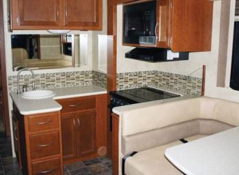 The 29-foot A.C.E. by Thor Motor Coach features a cozy street-side galley just aft of the dinette.