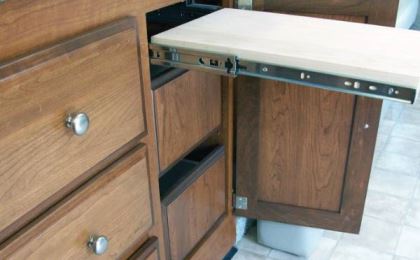 Convenient feautres in the galley include a bank of drawers and a pull-out cutting board,