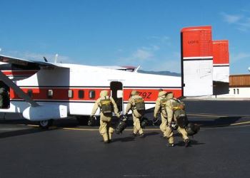 Smokejumpers from the Missoula base board a Shorts Sherpa C-23 plane to stop a fire 400 miles away.