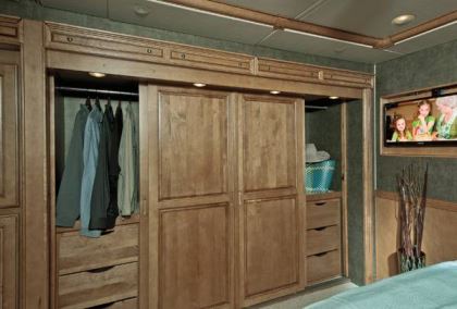 The curbside wardrobe in the Winnebago Journey 42E is as wide as the queen-size bed across from it.
