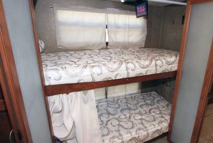 Curbside, each bunk bed area has its own window and drapes.
