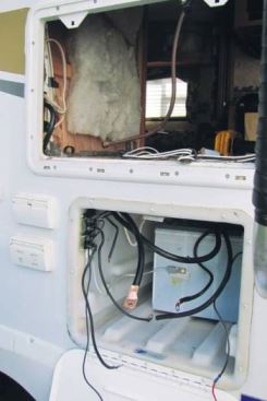 The installation involved removing the refrigerator and the power distribution panel so as to connect with the RV wiring.