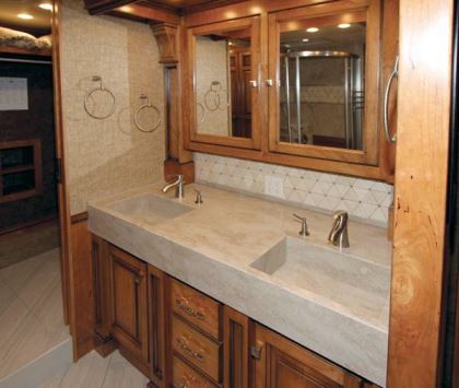 A full bath, with dual sinks, is between the bedroom and rear walk-in wardrobe.