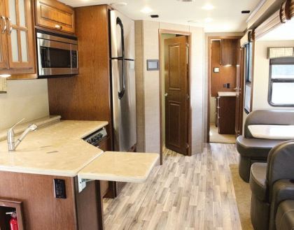 Inside the Isata 5 Series, a 165-inch-wide slideout enlarges the galley, dining, and living areas.
