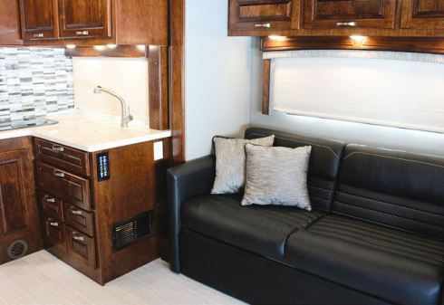 A slideout on the streetside encases a queen-size sofa bed; aft of it is the L-shaped galley work area.