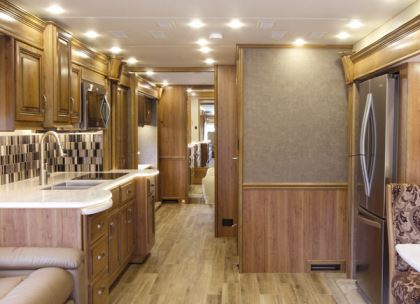 The Insignia 44B's open interior features Amish-crafted cabinets, natural cherry woodwork, and wood-look porcelain tile flooring.