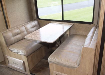 The booth dinette, which contains under-seat storage, can be converted to make a bed.