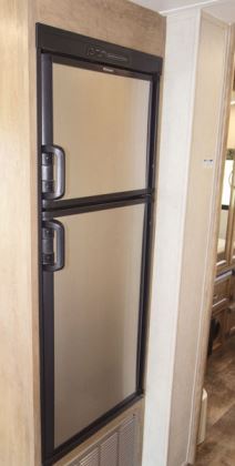 A 6-cubic-foot two-way refrigerator-freezer is across the aisle, aft of the entry.