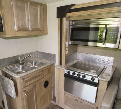 The BT Cruiser's galley includes a stainless-steel sink, stove, and microwave oven; the latter two are housed in the street-side slideout.