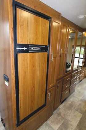 Just aft of the 32N’s entry steps, a two-door refrigerator is flanked by a pantry and a linen closet.