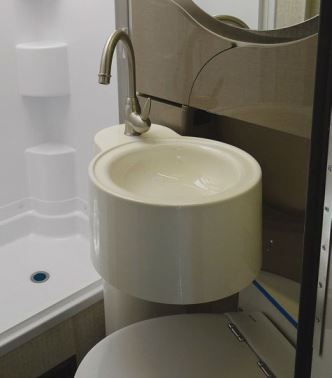  The sink swings over the toilet when the shower is used.