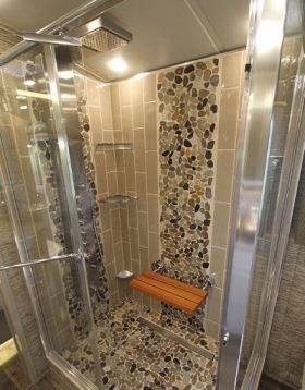 Bathroom amenities include a tiled shower with a fold-down teak seat.