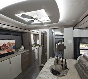 The bedroom features a king-size bed, a 42-inch TV on a power lift, and a ceiling fan with recessed LED lighting.