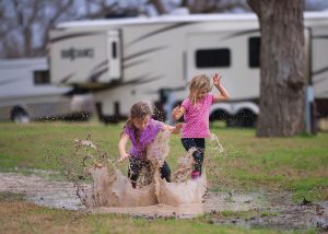 After a couple of days of rain in Columbus, Texas, Leighton (left) and Shayla Braga were allowed to venture outside and splash in puddles.