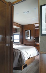 Sliding doors provide privacy in the rear bedroom, which features a king-size bed.