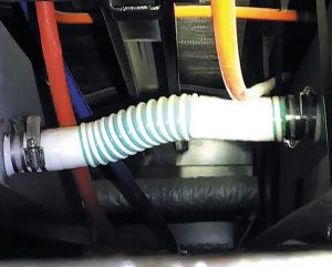 A plastic hose connects two parallel fresh-water tanks in this RV.