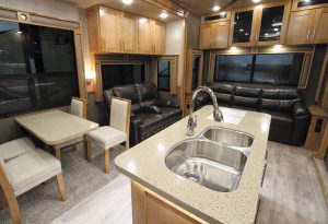 The Vanleigh Vilano 320GK contains a center island, hardwood cabinets, and solid-surface counters.
