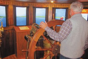Visitors are welcome at the helm inside a restored pilot house at the Door County Maritime Museum.
