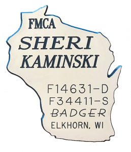 The Kaminskis' Badger chapter badges reflect that they are second-generation FMCA members.