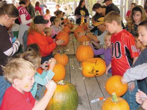 The fun at Lake Rudolph Campground & RV Resort includes pumpkin decorating.