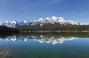 A still day on Herbert Lake along Alberta’s 144-mile Icefields Parkway, linking Lake Louise and Jasper, photographed by Sandra Elks.