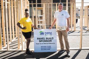 Dometic employees worked alongside Maleka Beard, left, building walls for her Habitat for Humanity house.