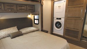 The head of the king-size bed in the Jayco Embark rests in a curbside slideout.