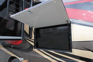 A 39-inch LED TV is secured under a weatherproof hatch in the patio area.