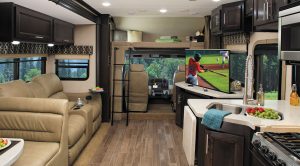The two-slideout 37BH floor plan incorporates a front cab-over berth, a sofa bed, and a convertible dinette, plus bunk beds and a master bedroom in the rear.