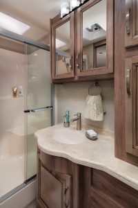 The bathroom in the Precept Prestige features a porcelain toilet and a 36-inch-by-42-inch shower with a full surround and a glass door.