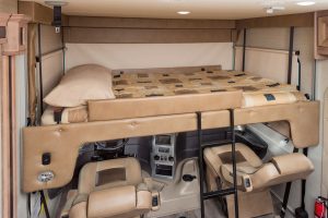 The optional powered drop-down overhead bunk in the Precept Prestige’s cab area is rated to hold 750 pounds. The pilot and copilot seats tilt backward to accommodate the lowered bed.