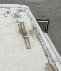 After sealant has been removed from fixtures and their screws have been taken out, carefully pry the fixtures off the roof.