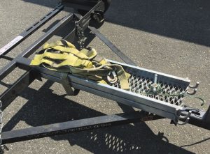 Galvanized steel ramps are stored right on Acme’s tow dollies.