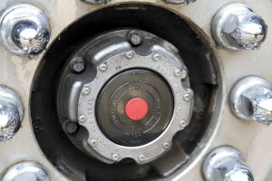 The clear plastic lens of a Stemco hub cover allows inspection of the wheel bearings’ gear lube level.