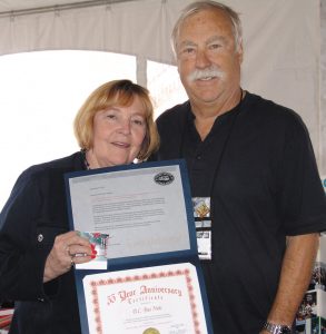 Kathie Balogh presents the B.C. Bus Nuts chapter’s 35th anniversary certificate to Gary Werschler.