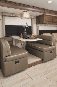 Ultraleather fabric covers seating throughout the motorhome, including a convertible booth with a solid-surface table. 