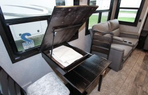 Inside the Jayco Eagle 355MBQS, the hinged dinette table conceals a storage compartment; 