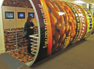 The steps involved in making and canning Bush’s baked beans are revealed inside a walk-through-size can.