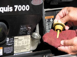 The oil level in the RV generator should be checked at least weekly to avoid activating the low-oil pressure switch.