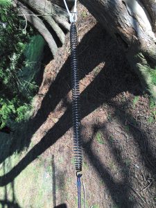 Replacing RV hydraulic jack springs via the author's method involves using cables to attach one end of the spring to a tree or post and the other end to a vehicle and stretching it slightly.