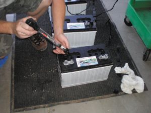 A hydrometer is used to test the state of charge of a cell in a flooded lead-acid battery. 