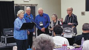 FMCA president Jon Walker (center) joined June and Leonard Davis (left) in welcoming Don and LaBerta Bibler to the FMCA family.