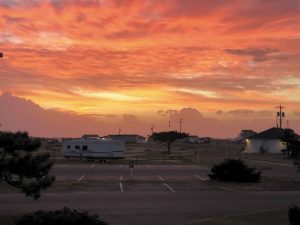 Sunrise paints the sky at Camp Hatteras Campground and Resort between Rodanthe and Waves, North Carolina, photographed by Rob Lilly. 